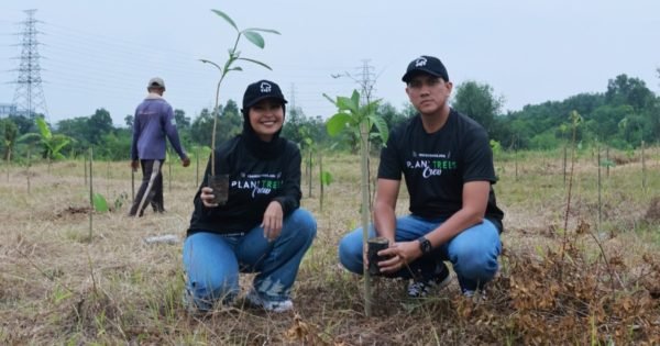 Arda and Tantri plant trees with Trees4Trees